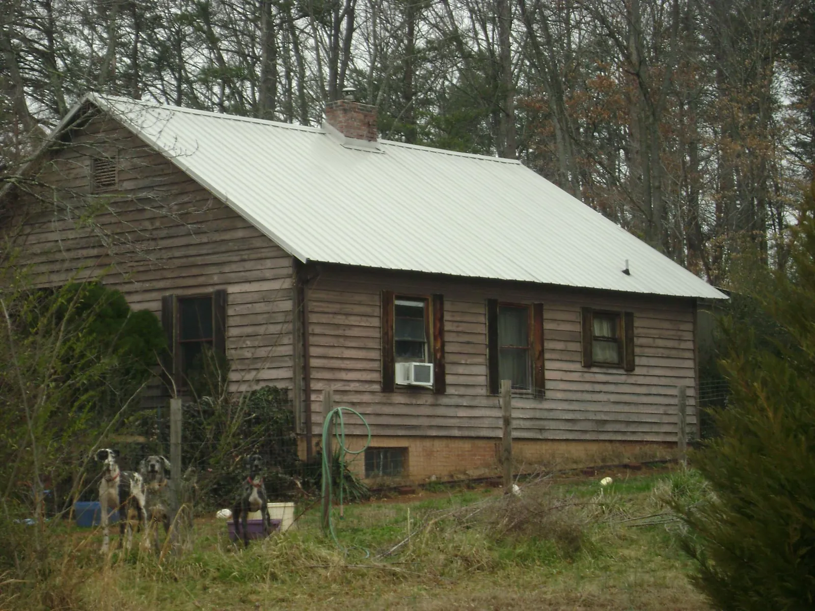White metal roof on an old wood sided farmhouse, from a Metal Roof Installation job in Braidwood